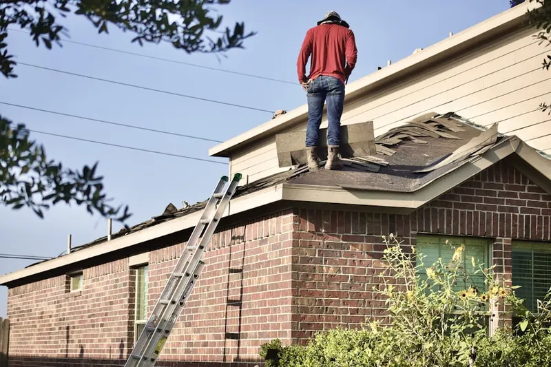 Professional roofer working on a residential roof in Gwynn Oaks